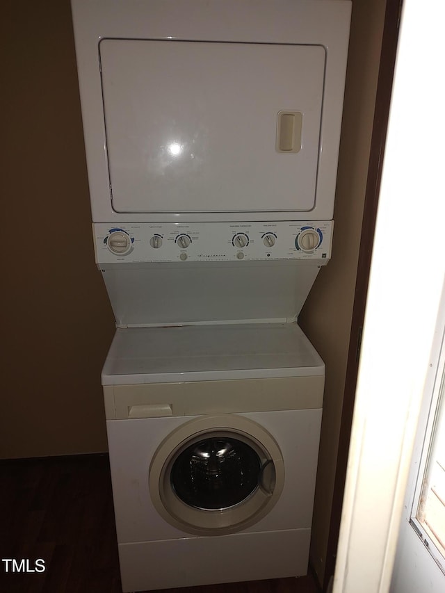 1161 Morgan Rd, Henderson, NC 27537 - washroom featuring stacked washer / dryer and dark wood finished floors