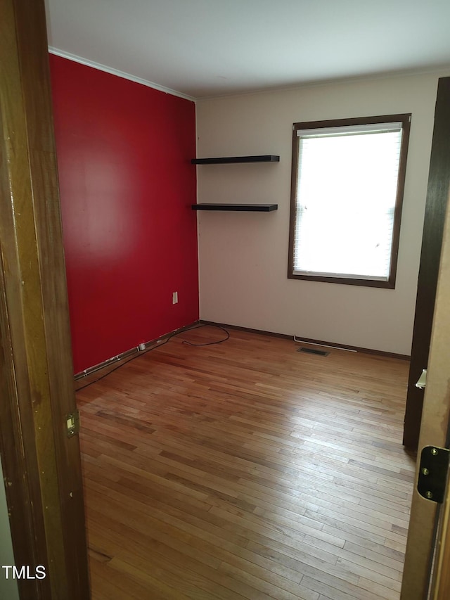 1161 Morgan Rd, Henderson, NC 27537 - unfurnished bedroom featuring wood finished floors and ornamental molding
