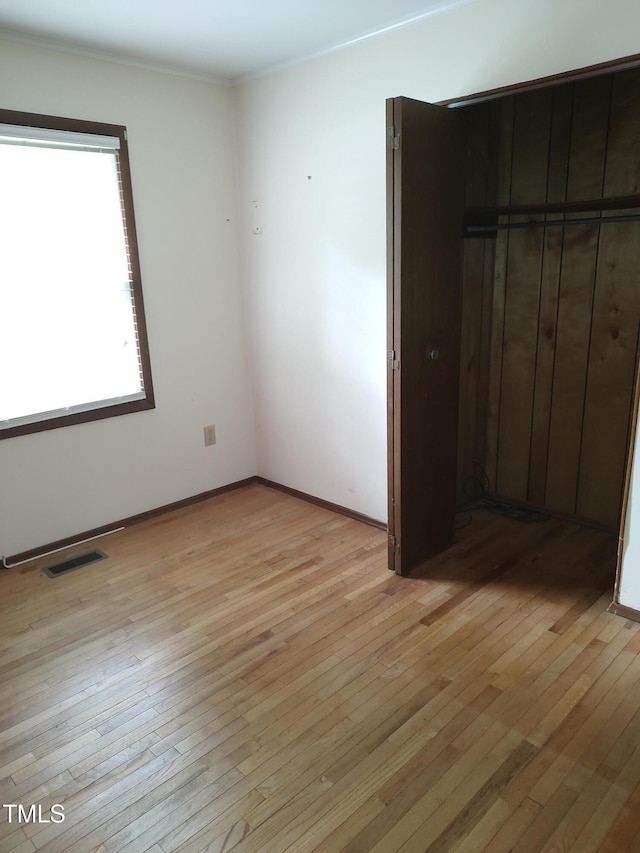 1161 Morgan Rd, Henderson, NC 27537 - unfurnished bedroom with light wood-type flooring and ornamental molding