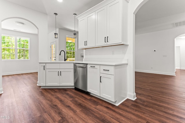 121 Quarterhorse Dr, Louisburg, NC 27549 - kitchen with stainless steel dishwasher, arched walkways, dark wood finished floors, and a peninsula