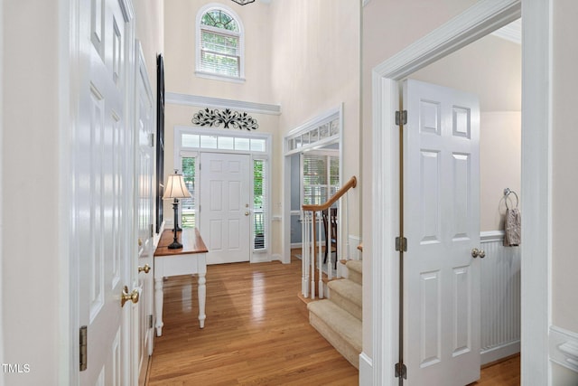 2608 Forestbluff Dr, Fuquay Varina, NC 27526 - entrance foyer with light wood-style flooring, a towering ceiling, and stairway