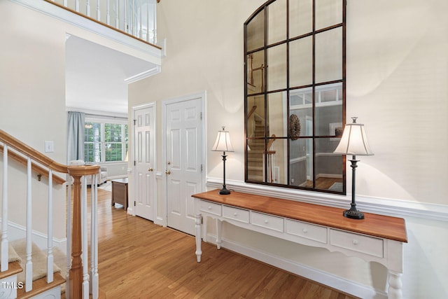 2608 Forestbluff Dr, Fuquay Varina, NC 27526 - entrance foyer featuring wood finished floors, stairway, and a towering ceiling