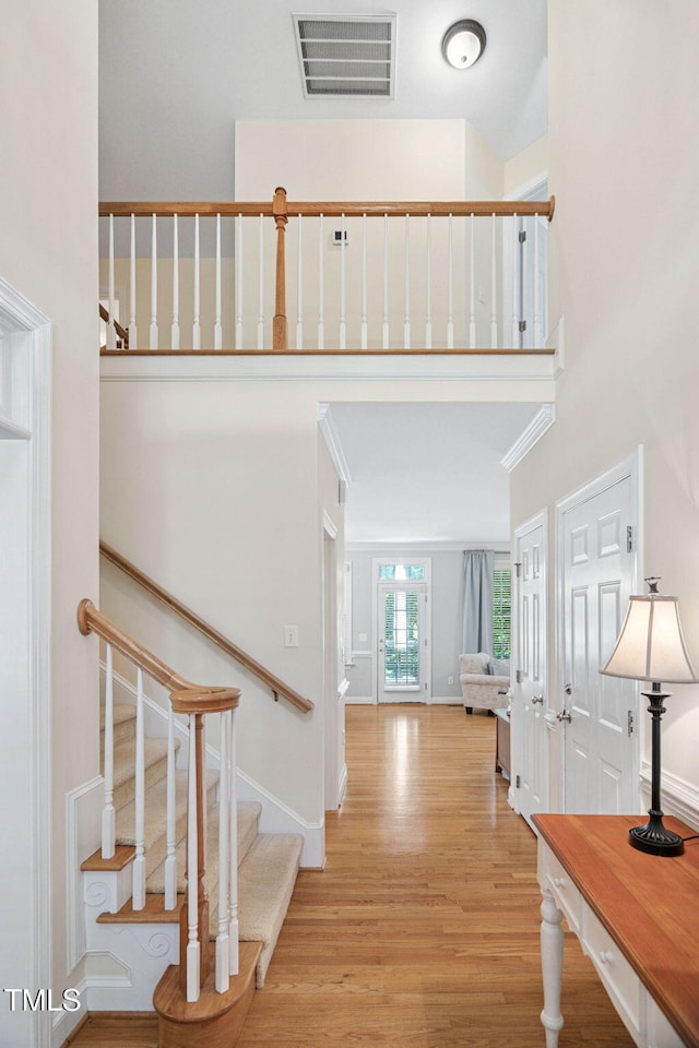 2608 Forestbluff Dr, Fuquay Varina, NC 27526 - foyer featuring wood finished floors, a high ceiling, and stairway
