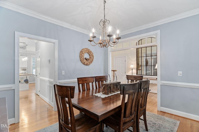2608 Forestbluff Dr, Fuquay Varina, NC 27526 - dining room with a chandelier, light wood-style flooring, and crown molding