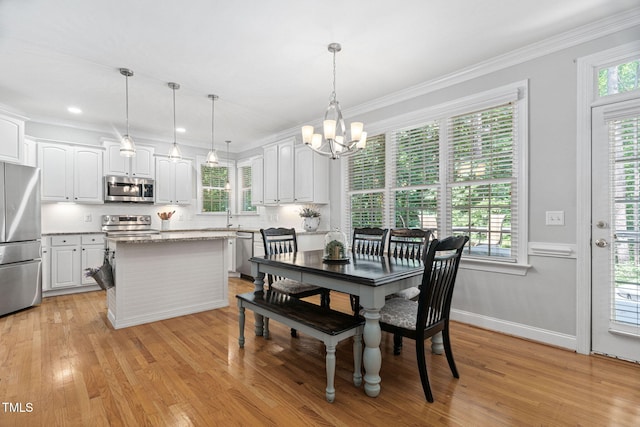 2608 Forestbluff Dr, Fuquay Varina, NC 27526 - dining area featuring a chandelier, crown molding, light wood finished floors, and recessed lighting