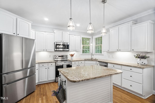 2608 Forestbluff Dr, Fuquay Varina, NC 27526 - kitchen with stainless steel appliances, white cabinets, ornamental molding, backsplash, and recessed lighting