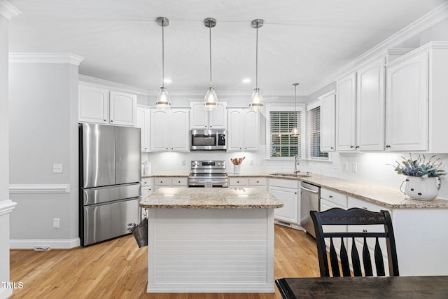 2608 Forestbluff Dr, Fuquay Varina, NC 27526 - kitchen featuring stainless steel appliances, white cabinets, light stone countertops, recessed lighting, and ornamental molding