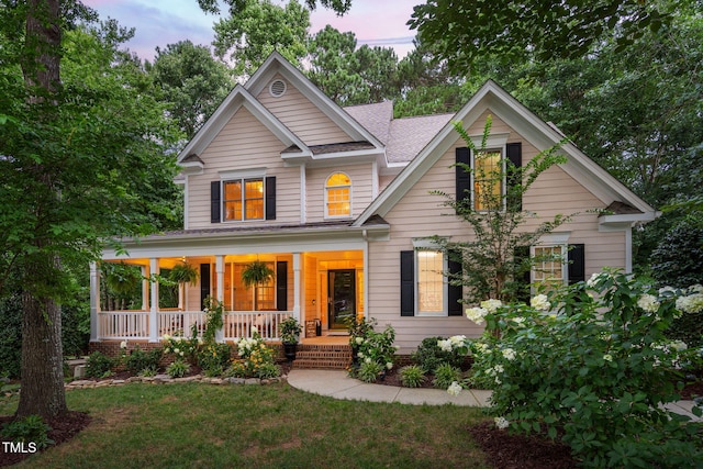 2608 Forestbluff Dr, Fuquay Varina, NC 27526 - view of front facade featuring covered porch, a shingled roof, and a front yard