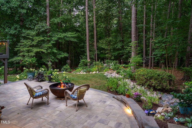 2608 Forestbluff Dr, Fuquay Varina, NC 27526 - view of patio / terrace with an outdoor fire pit and a wooded view