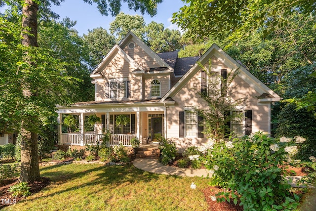 2608 Forestbluff Dr, Fuquay Varina, NC 27526 - view of front of house featuring covered porch and a front yard