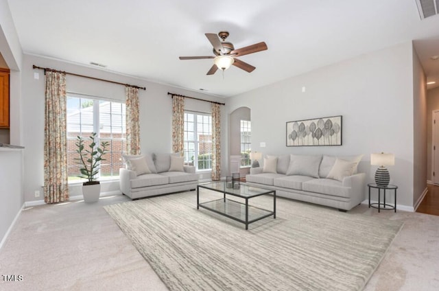 732 Hornchurch Loop, Cary, NC 27519 - living room with ceiling fan, arched walkways, and carpet flooring