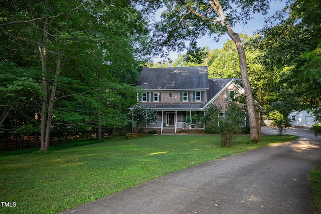 900 Stonecutter Ct, Raleigh, NC 27614 - colonial inspired home featuring covered porch, a front lawn, and driveway