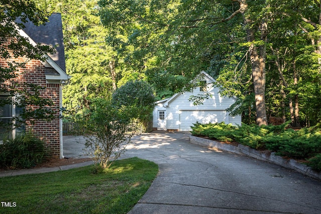 900 Stonecutter Ct, Raleigh, NC 27614 - view of property exterior with a garage, driveway, an outbuilding, and brick siding