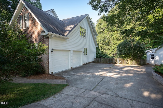 900 Stonecutter Ct, Raleigh, NC 27614 - view of side of property featuring brick siding, roof with shingles, concrete driveway, and a garage