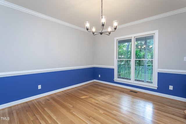 900 Stonecutter Ct, Raleigh, NC 27614 - unfurnished room with a chandelier, wood finished floors, and crown molding