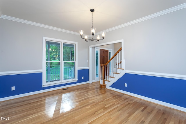900 Stonecutter Ct, Raleigh, NC 27614 - empty room featuring a chandelier, stairway, crown molding, and wood finished floors