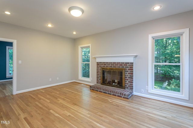 900 Stonecutter Ct, Raleigh, NC 27614 - unfurnished living room featuring wood finished floors, a brick fireplace, and recessed lighting