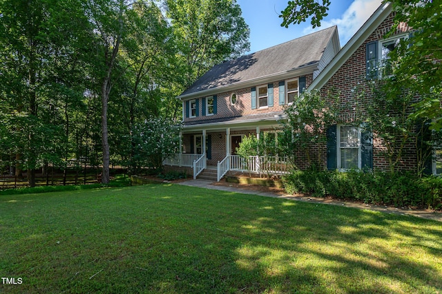900 Stonecutter Ct, Raleigh, NC 27614 - view of front of house with covered porch, a front yard, brick siding, and a shingled roof