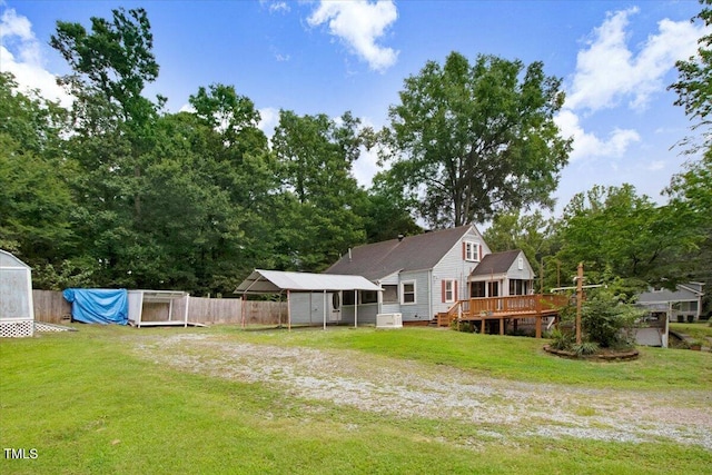607 E Geer St, Durham, NC 27701 - back of house with a carport, a deck, a storage unit, and driveway