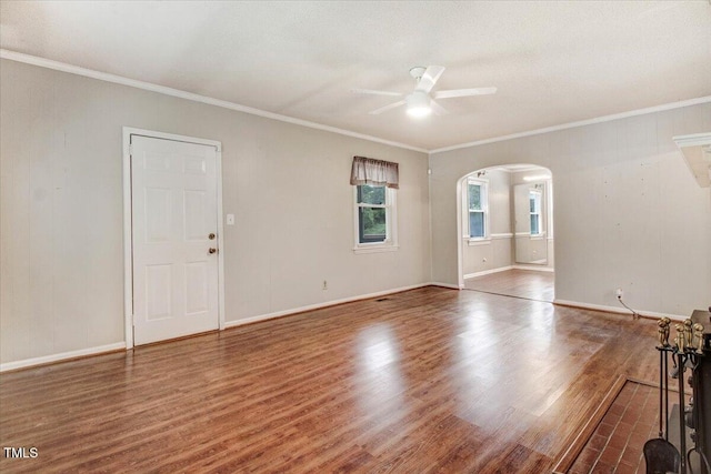 607 E Geer St, Durham, NC 27701 - unfurnished living room featuring arched walkways, a ceiling fan, wood finished floors, and crown molding