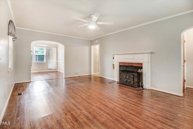 607 E Geer St, Durham, NC 27701 - unfurnished living room with arched walkways, a ceiling fan, wood finished floors, a fireplace with flush hearth, and ornamental molding