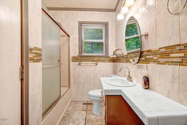 607 E Geer St, Durham, NC 27701 - full bathroom featuring vanity, enclosed tub / shower combo, ornamental molding, tile patterned floors, and tile walls