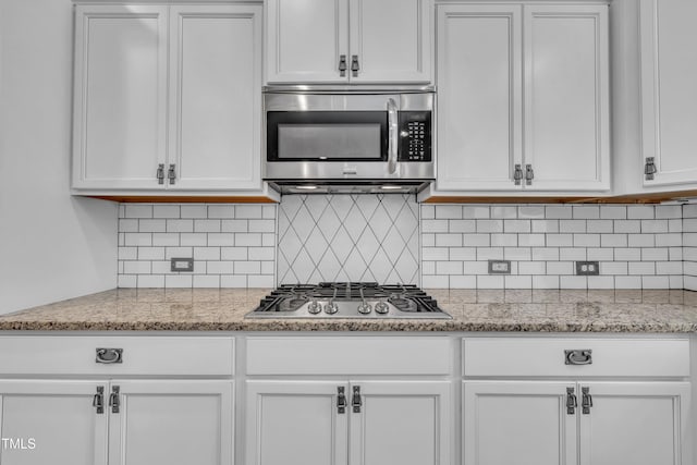 211 Camille Cir, Youngsville, NC 27596 - kitchen featuring appliances with stainless steel finishes, white cabinets, decorative backsplash, and light stone countertops