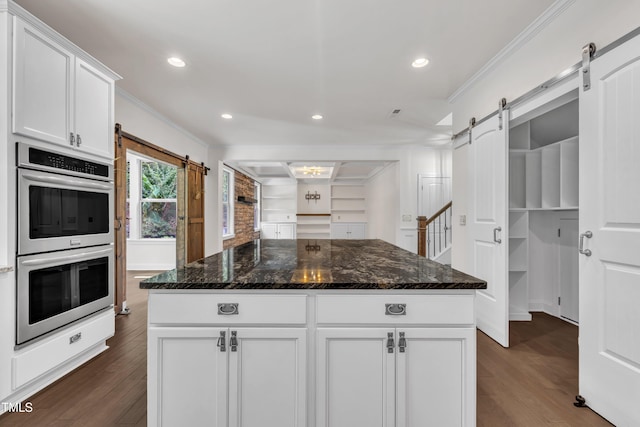 211 Camille Cir, Youngsville, NC 27596 - kitchen featuring a barn door, stainless steel double oven, crown molding, dark wood-style floors, and recessed lighting