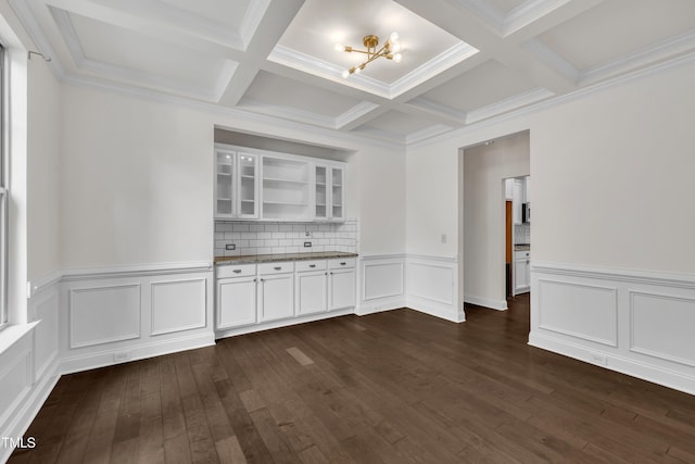 211 Camille Cir, Youngsville, NC 27596 - empty room with beamed ceiling, coffered ceiling, dark wood finished floors, a wainscoted wall, and a decorative wall