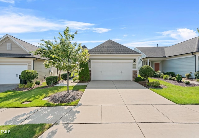 325 Currituck Ln, Durham, NC 27703 - view of front of home featuring an attached garage, a front lawn, driveway, stone siding, and a shingled roof