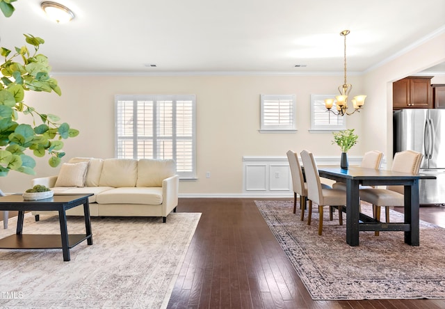 325 Currituck Ln, Durham, NC 27703 - dining area with a chandelier, healthy amount of natural light, crown molding, and dark wood finished floors