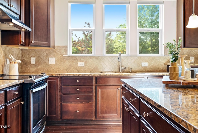 325 Currituck Ln, Durham, NC 27703 - kitchen featuring under cabinet range hood, stainless steel electric stove, healthy amount of natural light, and light stone counters