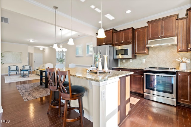 325 Currituck Ln, Durham, NC 27703 - kitchen with stainless steel appliances, exhaust hood, dark wood-type flooring, light stone counters, and a kitchen island