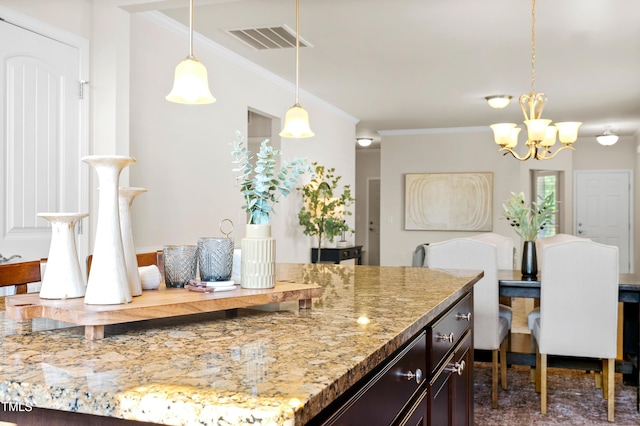 325 Currituck Ln, Durham, NC 27703 - kitchen featuring a chandelier, dark brown cabinets, ornamental molding, light stone countertops, and pendant lighting