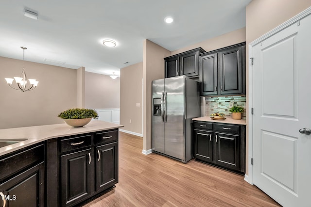 401 Summit Trail Dr, Hillsborough, NC 27278 - kitchen with stainless steel fridge with ice dispenser, dark cabinets, light countertops, backsplash, and hanging light fixtures