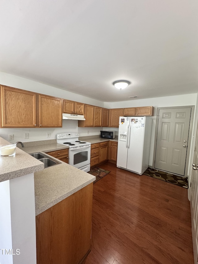 2907 S S Roxboro St, Durham, NC 27707 - kitchen with white appliances, under cabinet range hood, light countertops, brown cabinets, and a peninsula
