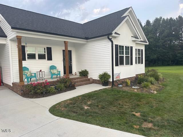 8 Open View Ln, Timberlake, NC 27583 - view of front of property featuring a porch, a front yard, and roof with shingles
