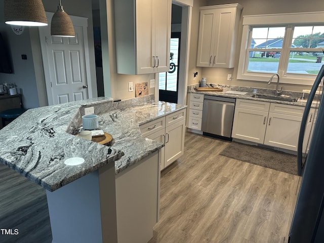8 Open View Ln, Timberlake, NC 27583 - kitchen with stainless steel dishwasher, a peninsula, light wood-style flooring, white cabinets, and black refrigerator