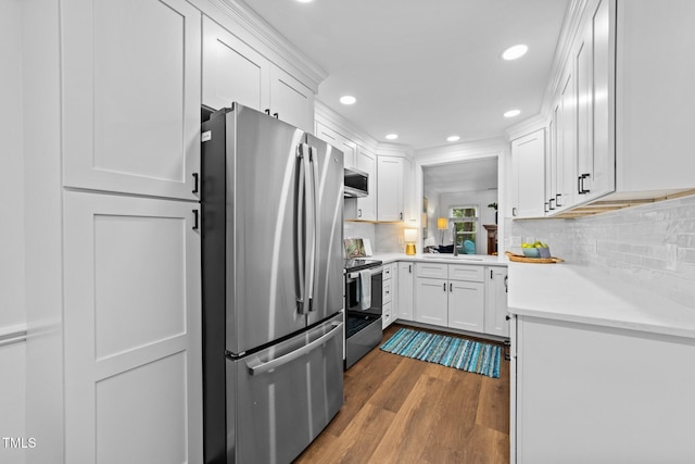 1035 High Lake Ct, Raleigh, NC 27606 - kitchen with stainless steel appliances, white cabinetry, dark wood-style floors, light countertops, and recessed lighting