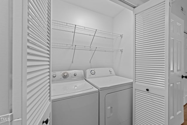 1035 High Lake Ct, Raleigh, NC 27606 - washroom featuring independent washer and dryer and wood finished floors