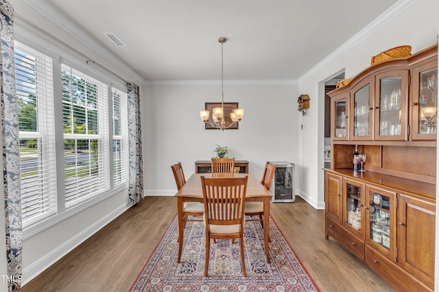1021 Clove Pine Dr, Knightdale, NC 27545 - dining space with wood finished floors, a chandelier, heating unit, and crown molding