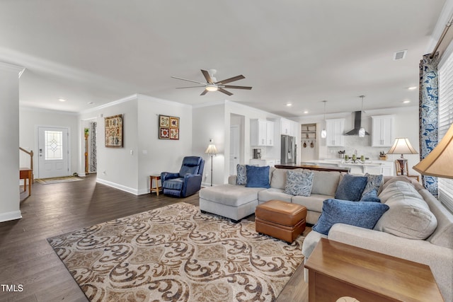 1021 Clove Pine Dr, Knightdale, NC 27545 - living room with crown molding, a ceiling fan, dark wood-style floors, recessed lighting, and stairs