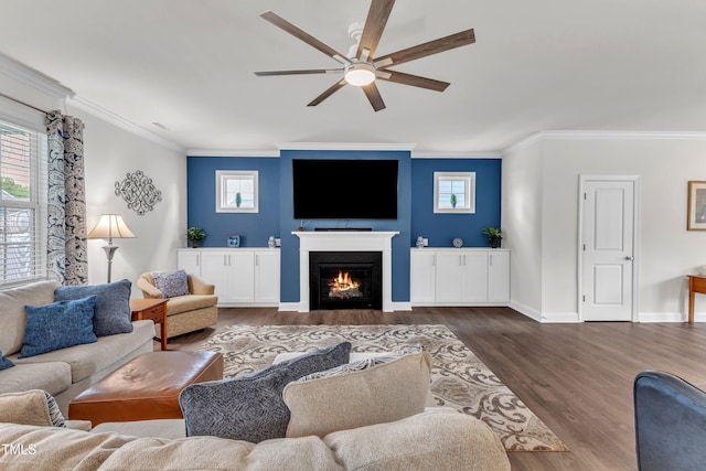 1021 Clove Pine Dr, Knightdale, NC 27545 - living area with ornamental molding, a ceiling fan, healthy amount of natural light, wood finished floors, and a lit fireplace