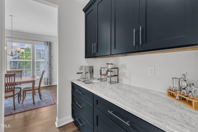 1021 Clove Pine Dr, Knightdale, NC 27545 - bar area with crown molding, a chandelier, dark wood-style flooring, and pendant lighting
