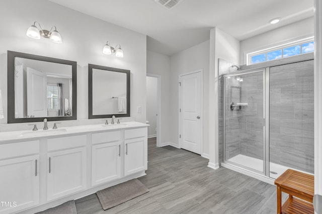 1021 Clove Pine Dr, Knightdale, NC 27545 - full bath featuring double vanity, a stall shower, and wood finished floors