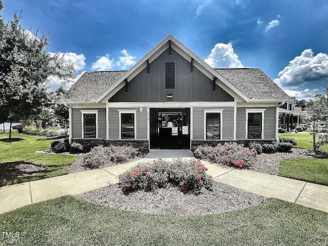 1021 Clove Pine Dr, Knightdale, NC 27545 - view of front facade featuring a front yard, a shingled roof, and stone siding
