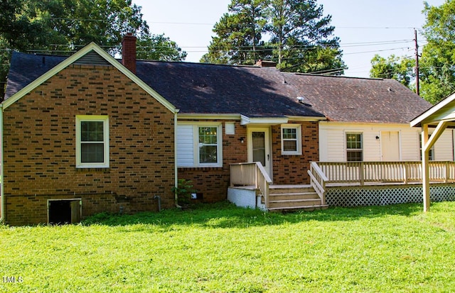 2001 Thomas Ln, Henderson, NC 27536 - view of front of house with a chimney, a front yard, a wooden deck, brick siding, and roof with shingles
