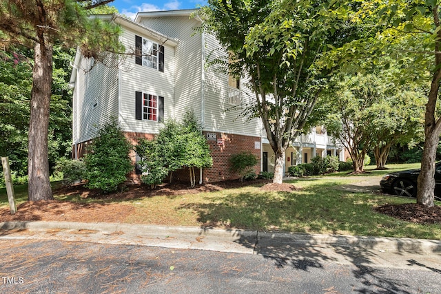 3050 Trailwood Pines Ln Unit 303, Raleigh, NC 27603 - view of front of home featuring brick siding and a front yard