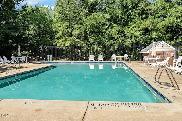 3050 Trailwood Pines Ln Unit 303, Raleigh, NC 27603 - community pool featuring a patio and view of scattered trees