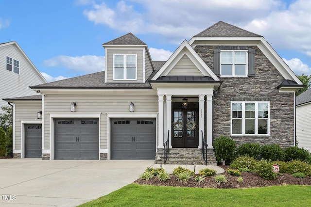 2098 Amalfi Pl, Apex, NC 27502 - view of front of home with stone siding, french doors, driveway, a garage, and a standing seam roof